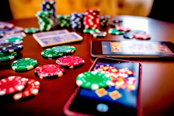 A professional dealer in a tuxedo greeting players at the roulette table, symbolizing the authentic live casino feel at JILI7979.