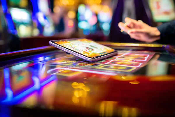 A person using their device against a moody casino-themed background, illustrating the smooth re-entry process at JILI7979.